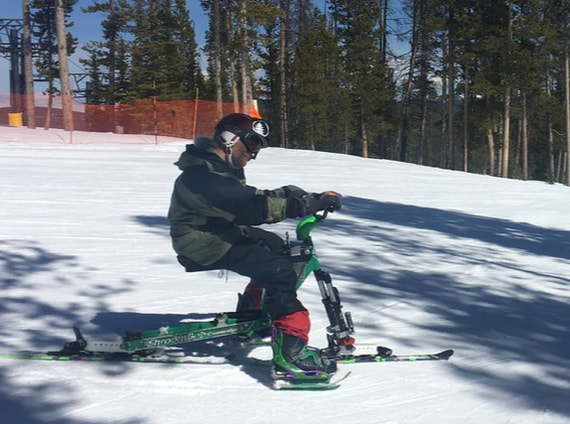 Picture of an iSkibike rider skiing a groomed ski run.